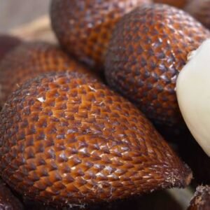 a collection of fresh and sweet snakefruit on a wooden table